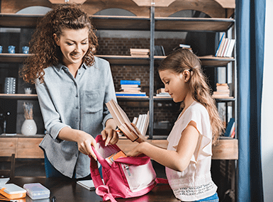mother checking child's backpack