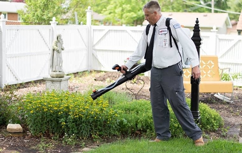 Professional pest control technician doing mosquito control.