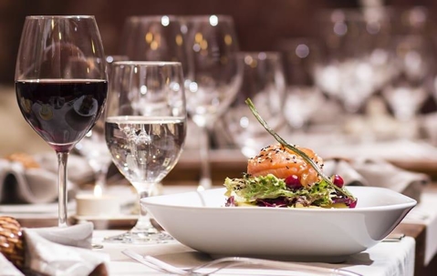 Restaurant salad together with red wine and water.