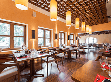 Clean, well-lit, empty restaurant during the day.