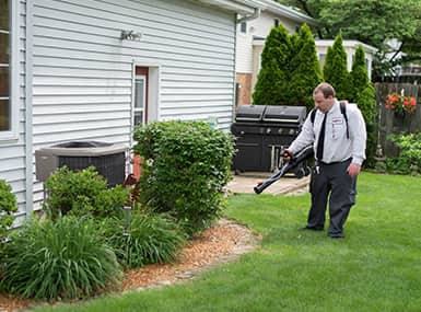 Professional pest control technician doing mosquito control.